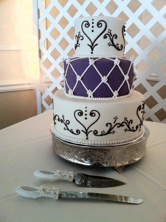 3 tier wedding cake in ivory purple and brown featuring royal icing lattice