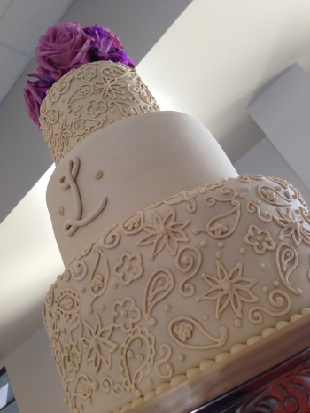"Rachael" 3 tier ivory wedding cake with paisley pattern and monogram out in Florala, AL at the edge of Lake Jackson.
